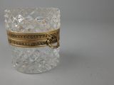 a close up of a glass container with a gold band around it