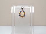 a close up of a glass display case with a necklace on it