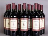 six bottles of wine are lined up in a row on a table