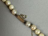 pearl necklace with a gold clasp and chain on a mannequin mannequin mannequin mannequin mannequin mannequin mannequin mann