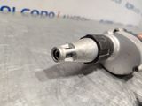 a close up of an electric drill on a metal surface