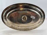a silver plate on a table with a tag on it