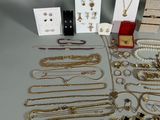 many different types of necklaces and bracelets laid out on a table