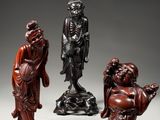 three chinese carved figurines of a man and a woman