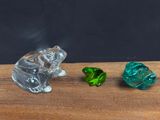 three glass animals sitting on a wooden table