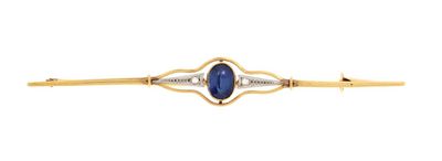 a close up of a gold and blue stone pin
