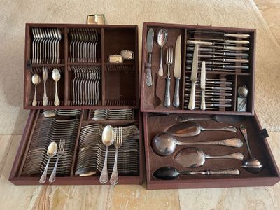 a wooden box with silverware in it on the floor