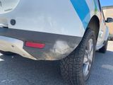 the rear end of a car with a blue and white stripe on the side of it