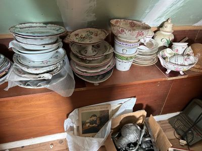 de nombreuses assiettes et bols posés sur une étagère dans une pièce