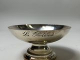 a close up of a silver bowl with writing on it