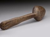 a wooden mallet with a wooden handle on a white surface