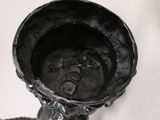 a black candle holder on a white table