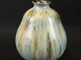 a small vase that is sitting on a black surface