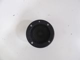 a black speaker sitting on top of a white sink