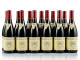six bottles of wine lined up in a row on a white surface