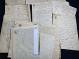 several old letters are stacked on top of each other on a table