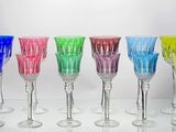 several different colored wine glasses are lined up on a table