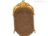 an image of a gold purse with a chain around it