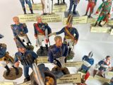 many figurines of military men on display in a glass case