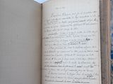 an open book with writing on it sitting on a table