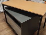 a desk with a drawer on top of it in a room