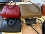 a lot of purses that are on a table
