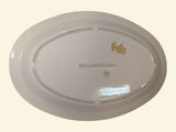 a white plate with a gold crown on it