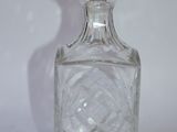 a clear glass bottle with a glass stopper on it