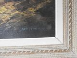 a picture of a painting of a mountain range in a frame