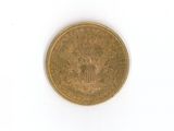 a close up of a gold coin on a white surface