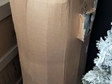 a cardboard bag sitting on top of a table next to a christmas tree