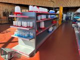 many empty shelves in the store with bottles on them