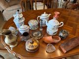 many different types of teapots on the table