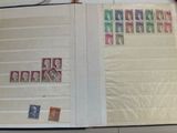 an open book with stamps on it on a table