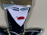 a picture of a brooch of a woman with a crown on her head