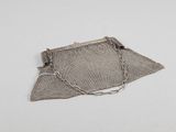 an old silver mesh purse with a chain around it