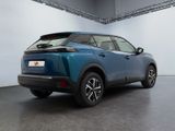 the rear end of a blue suv parked in a garage