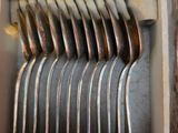 a lot of spoons and forks in a box