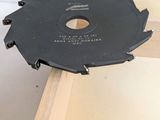 someone is using a circular saw to cut a piece of wood