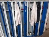 two lockers with coats hanging on them in a room