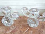 pair of clear glass candlesticks on a marble table
