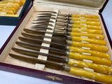 many knives in a case that are sitting on a table