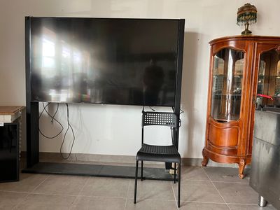 a black chair sitting in front of a flat screen tv