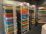 a lot of folders on the shelves in the store