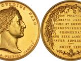 a close up of a gold coin with a woman ' s face on it