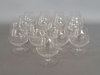 many empty wine glasses lined up on a table