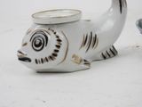 a white vase with a black and gold fish on it