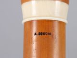 a close up of a wooden stick with writing on it
