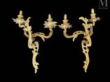 a pair of antique wall sconces with flowers and leaves