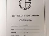 a close up of a certificate on a white paper with a black and white logo